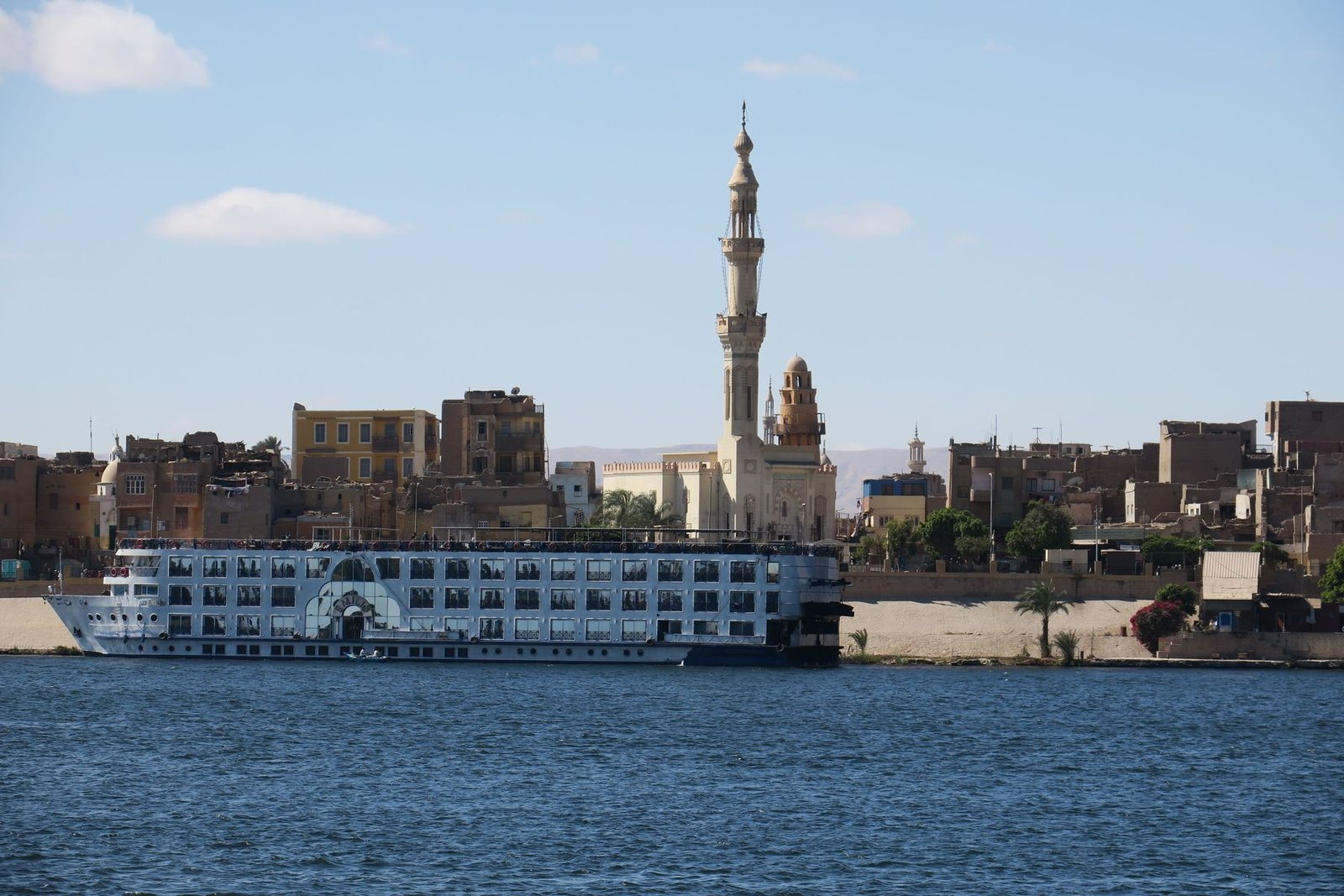 A cruiser moored below the minarets at Esna